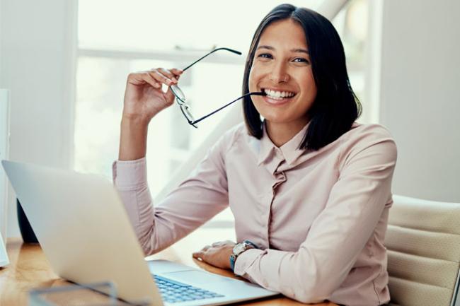 Woman smiling in front of a computer